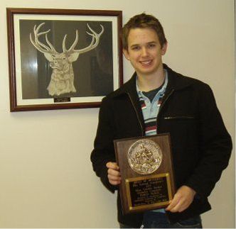 Brian Monahan holding award plaque